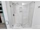 Walk-in shower with pebble floor and glass enclosure at 4754 Hedgemore Dr # T, Charlotte, NC 28209