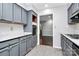 Modern kitchen with gray cabinets and marble countertops at 4754 Hedgemore Dr # T, Charlotte, NC 28209