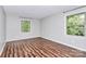 Well-lit bedroom with hardwood floors and two windows at 4754 Hedgemore Dr # T, Charlotte, NC 28209