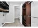 Walk-in closet with custom shelving and hanging rods at 4754 Hedgemore Dr # T, Charlotte, NC 28209