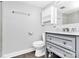 Updated bathroom with gray vanity, marble countertop, and shower at 4754 Hedgemore Dr # T, Charlotte, NC 28209
