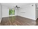 Living room with dark hardwood floors and sliding doors at 4754 Hedgemore Dr # T, Charlotte, NC 28209