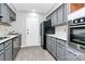 Modern kitchen with gray cabinets and marble countertops at 4754 Hedgemore Dr # T, Charlotte, NC 28209