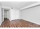 Bedroom with wood-look floors and double door closet at 4754 Hedgemore Dr # T, Charlotte, NC 28209