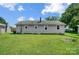 Large backyard with grassy lawn and outbuildings at 115 Abernathy St, Mount Holly, NC 28120