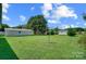 Spacious backyard with a playset and storage shed at 115 Abernathy St, Mount Holly, NC 28120