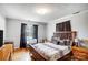 Bright bedroom with a double bed, wooden dresser, and window coverings at 115 Abernathy St, Mount Holly, NC 28120