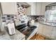 Updated kitchen with gray cabinets and a gas cooktop at 115 Abernathy St, Mount Holly, NC 28120