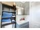 Clean bathroom with gray vanity, shelving, and blue towels at 115 Abernathy St, Mount Holly, NC 28120
