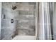 Bathroom with gray marble tile shower and tub at 115 Abernathy St, Mount Holly, NC 28120