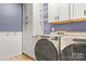 Bright laundry room, featuring modern washer and dryer, ample cabinetry, and stylish finishes at 4759 Polo Gate Blvd, Charlotte, NC 28216