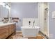 Spa-like bathroom featuring a soaking tub, double vanity, and walk-in shower at 4759 Polo Gate Blvd, Charlotte, NC 28216