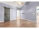 Well-lit bedroom featuring hardwood floors and a barn door at 4759 Polo Gate Blvd, Charlotte, NC 28216