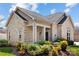 Stone and siding exterior with covered porch and manicured landscaping at 4759 Polo Gate Blvd, Charlotte, NC 28216