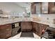 Modern kitchen with granite countertops, dark wood cabinets, and stainless steel appliances at 18641 Harborside Dr, Cornelius, NC 28031