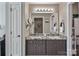 Double vanity bathroom with granite countertops and a large mirror at 18641 Harborside Dr, Cornelius, NC 28031