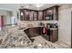 Granite countertops and dark wood cabinets are featured in this kitchen at 18641 Harborside Dr, Cornelius, NC 28031