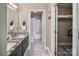 Double vanity bathroom with granite countertops and adjacent closet at 18641 Harborside Dr, Cornelius, NC 28031