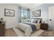 Charming bedroom with hardwood floors and a window overlooking the backyard at 4759 Polo Gate Blvd, Charlotte, NC 28216