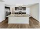 Modern kitchen with dark cabinetry, granite island, and stainless steel appliances at 598 Shellbark Dr, Concord, NC 28025