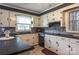 L-shaped kitchen with white cabinets and dark countertops at 3913 Belk Mill Rd, Wingate, NC 28174