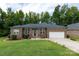 Brick ranch home with a two car garage and manicured lawn at 133 Ole Eastpointe Dr, York, SC 29745