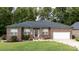 Brick ranch house with a two-car garage and landscaped yard at 133 Ole Eastpointe Dr, York, SC 29745