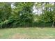 Large backyard with a privacy fence and fire pit at 133 Ole Eastpointe Dr, York, SC 29745