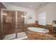 Spa-like bathroom with soaking tub, walk-in shower, and tiled walls at 4050 Halyard Dr, Denver, NC 28037