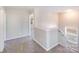 Upstairs hallway with carpet and access to bedrooms at 13315 Hunting Birds Ln, Charlotte, NC 28278