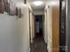 Long hallway with wood-look flooring and framed photos at 4040 Angus Dr, Gastonia, NC 28056