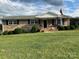 Brick ranch house with a well-maintained lawn and covered porch at 4040 Angus Dr, Gastonia, NC 28056