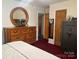 Bedroom with large dresser, mirror, and a safe at 4040 Angus Dr, Gastonia, NC 28056