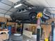 A car on a lift in a well-lit garage with tools and tires at 4040 Angus Dr, Gastonia, NC 28056