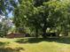 Two wooden outbuildings on a grassy lot with large trees at 1270 Stanback Rd, Mount Gilead, NC 27306