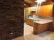 Kitchen with wood cabinets and brick wall at 1270 Stanback Rd, Mount Gilead, NC 27306