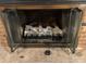 Brick fireplace with glass doors and gas logs at 1270 Stanback Rd, Mount Gilead, NC 27306