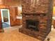 Brick fireplace in living area with wood-paneled walls at 1270 Stanback Rd, Mount Gilead, NC 27306