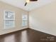 Simple bedroom with hardwood floors and two windows at 15021 New Amsterdam Ln, Charlotte, NC 28204