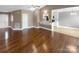 Open living room with hardwood floors and kitchen access at 1151 Glenbriar Ct, Woodleaf, NC 27054