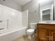 Clean bathroom with a tub, toilet and wood vanity at 2510 Doster Rd, Monroe, NC 28112
