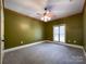 Spacious bedroom with green walls and neutral carpeting at 2510 Doster Rd, Monroe, NC 28112