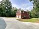 Brick home with a three-car garage and landscaping at 2510 Doster Rd, Monroe, NC 28112