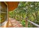 Wooden deck with railing offering scenic views of the surrounding trees at 241 Spring Shore Rd, Statesville, NC 28677