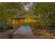 Round house exterior with a charming green door and walkway at 241 Spring Shore Rd, Statesville, NC 28677