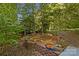 Landscaped backyard with brick planters and lush greenery at 241 Spring Shore Rd, Statesville, NC 28677