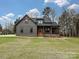 Front exterior of a modern gray farmhouse with a covered porch and landscaping at 1467 Centennial Dr, Rock Hill, SC 29732