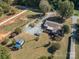 Aerial view of a ranch home with a large yard and detached workshop at 316 W Sandy Ridge Rd, Monroe, NC 28112