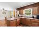 Cozy kitchen featuring wood cabinets, a breakfast bar, and ample counter space at 1208 Clarksville Campground Rd, Monroe, NC 28112