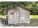 Tan storage shed with chicken coop and decorative owl at 1208 Clarksville Campground Rd, Monroe, NC 28112